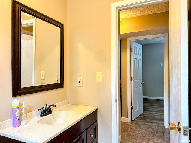 bathroom featuring a textured ceiling, vanity, and hardwood / wood-style flooring