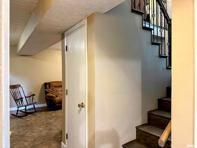 stairway with a textured ceiling