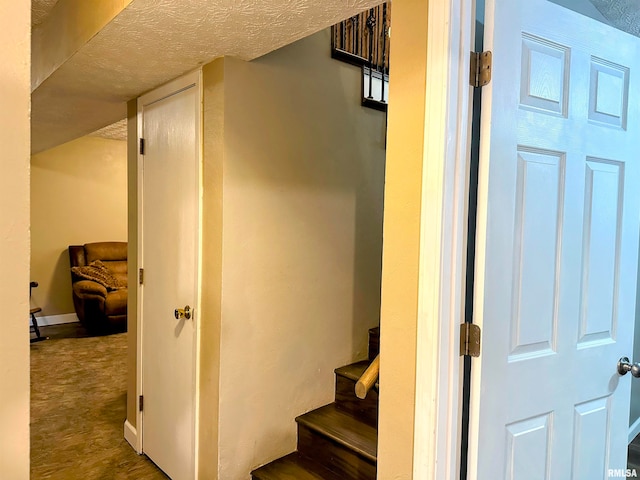 stairway with a textured ceiling