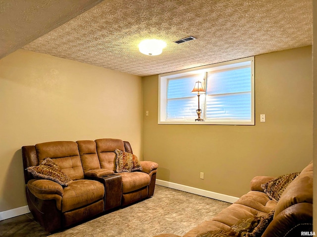 living room with carpet floors and a textured ceiling