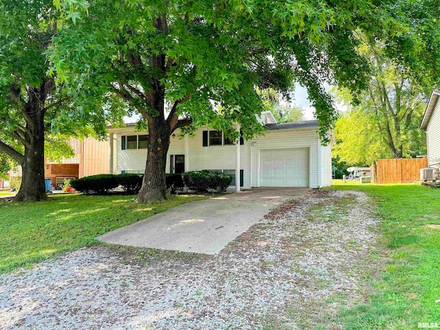 view of front of house featuring a garage and a front lawn