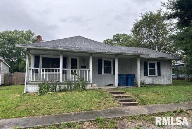 view of front of home with a porch and a front yard