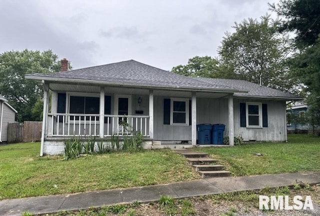 view of front of property featuring covered porch and a front yard