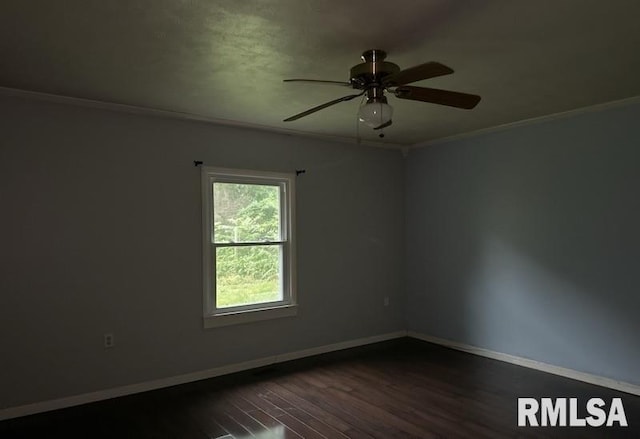 empty room with ornamental molding, ceiling fan, and dark hardwood / wood-style flooring