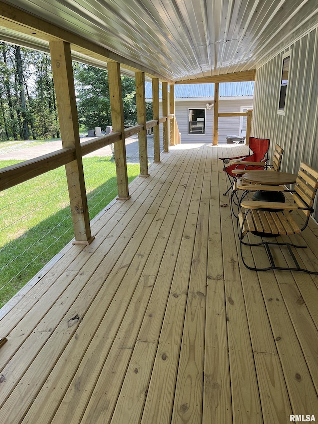 wooden deck featuring a yard