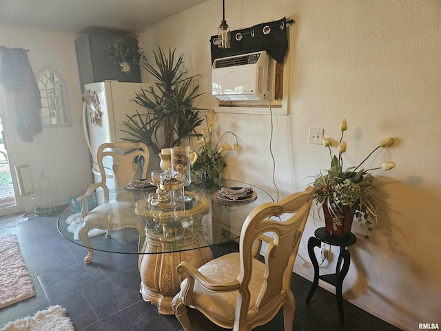 tiled dining space featuring an AC wall unit and crown molding