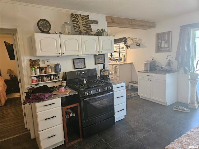 kitchen with white cabinets, crown molding, a wealth of natural light, and black gas stove