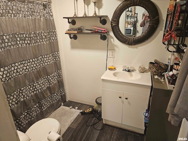 bathroom with a shower with curtain, toilet, vanity, and wood-type flooring