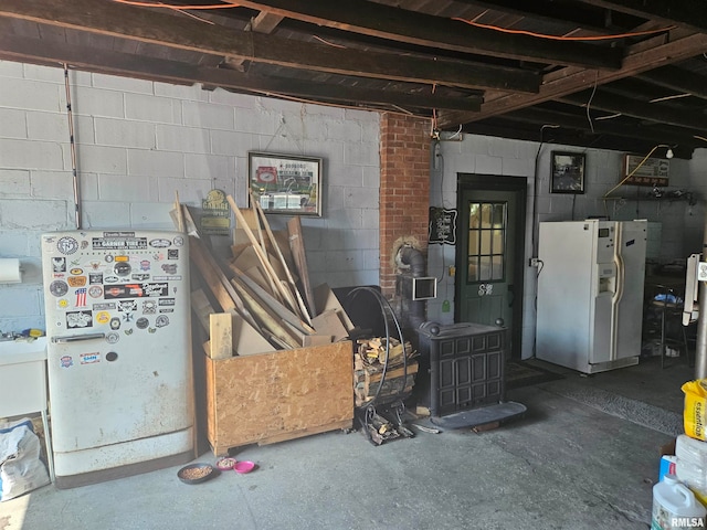 basement featuring white fridge with ice dispenser