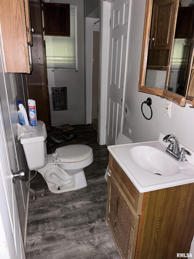 bathroom with hardwood / wood-style floors, vanity, and toilet