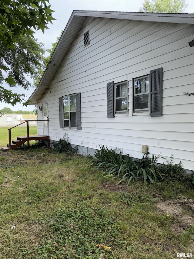 view of side of property with a lawn