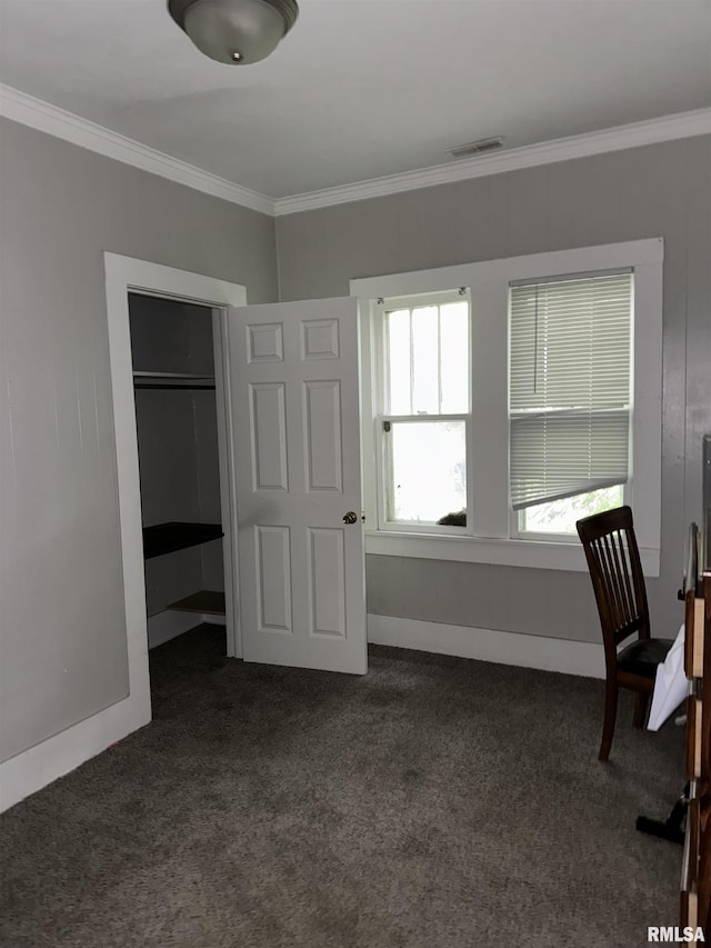 unfurnished office with dark carpet and crown molding