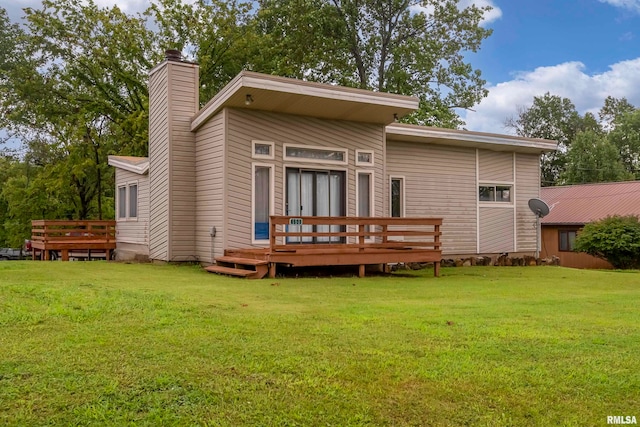 back of house featuring a yard and a deck