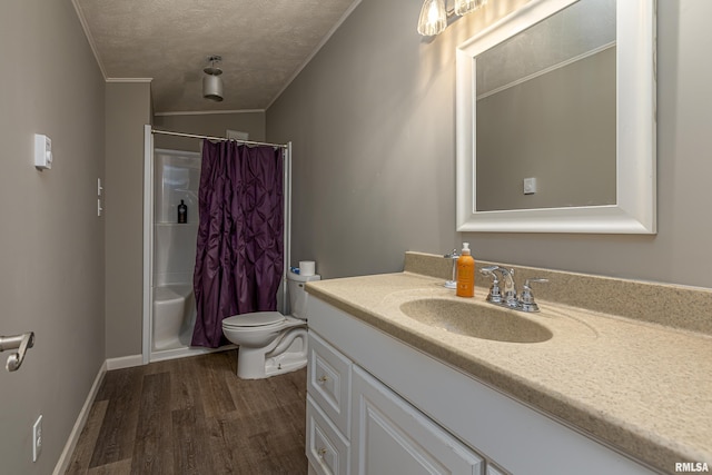 full bathroom with crown molding, shower / tub combo, hardwood / wood-style floors, vanity, and toilet