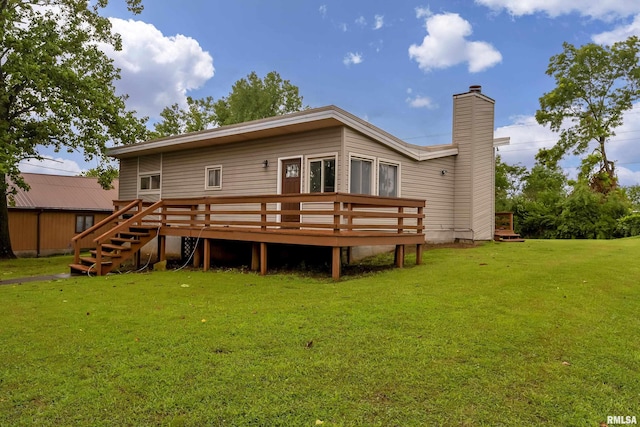 rear view of property featuring a deck and a lawn