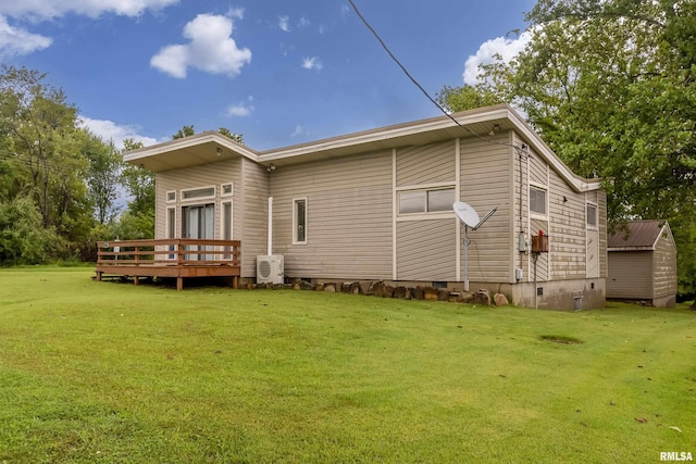 back of property featuring a wooden deck, ac unit, and a lawn