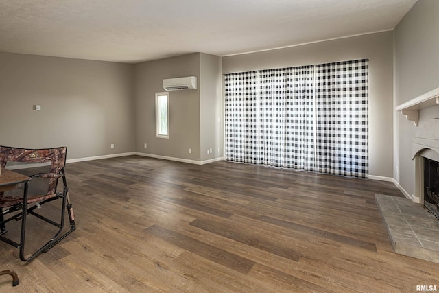 living room with dark hardwood / wood-style flooring and an AC wall unit