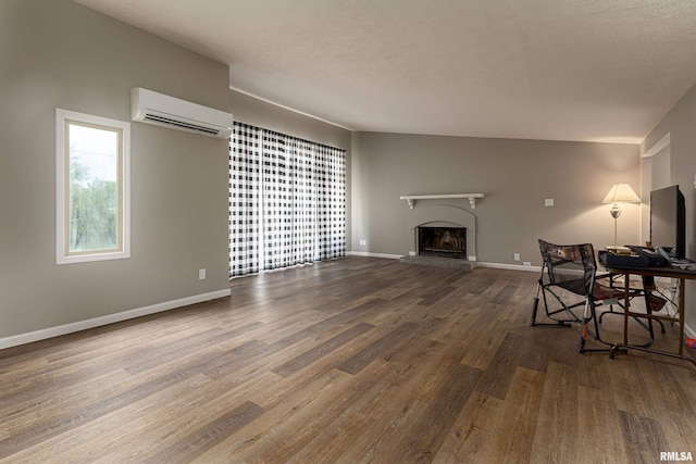 sitting room featuring hardwood / wood-style floors and a wall mounted air conditioner