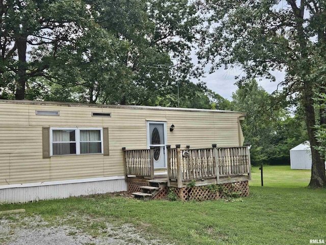 view of front of house featuring a deck and a front lawn