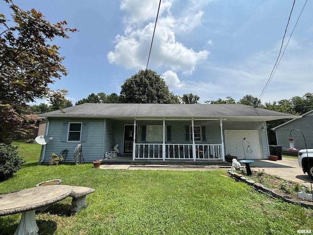 view of front of property featuring a garage, covered porch, and a front yard