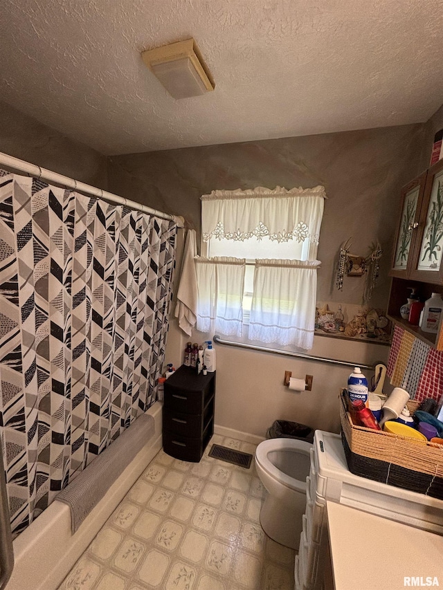 bathroom with a textured ceiling, toilet, a shower with shower curtain, and vanity