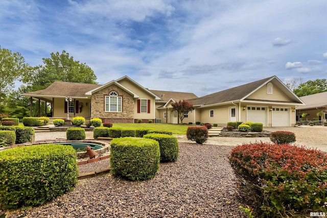 single story home featuring a garage and covered porch