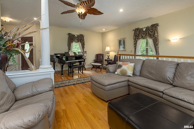 living room featuring ceiling fan, decorative columns, hardwood / wood-style floors, and a wealth of natural light