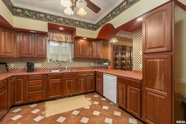 kitchen with decorative light fixtures, sink, ceiling fan, white dishwasher, and crown molding