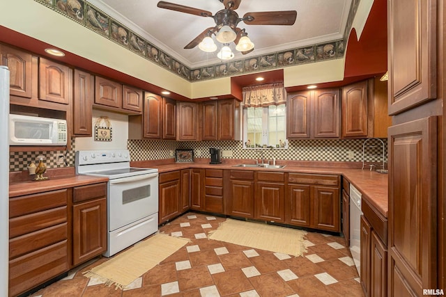 kitchen featuring sink, crown molding, white appliances, tasteful backsplash, and ceiling fan