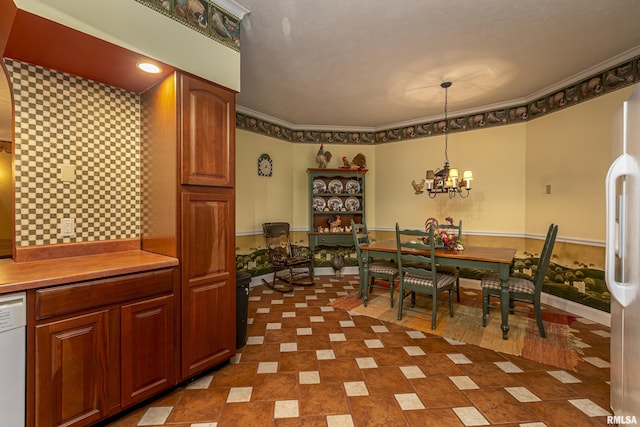 dining area with an inviting chandelier and ornamental molding