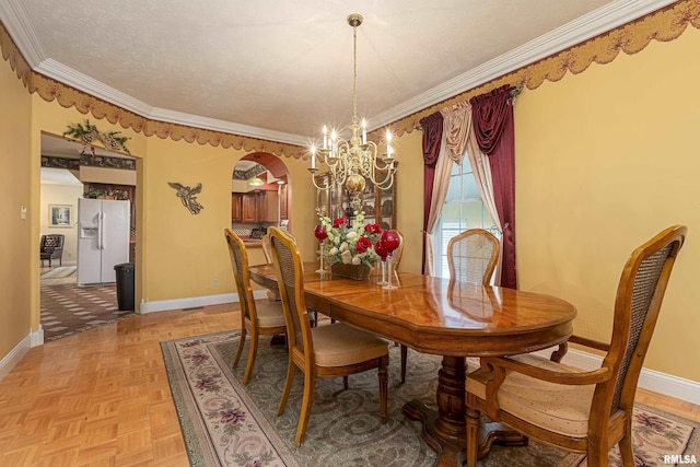 dining room featuring a notable chandelier, ornamental molding, and light parquet floors