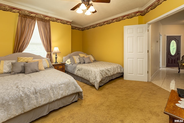 carpeted bedroom with ceiling fan and ornamental molding