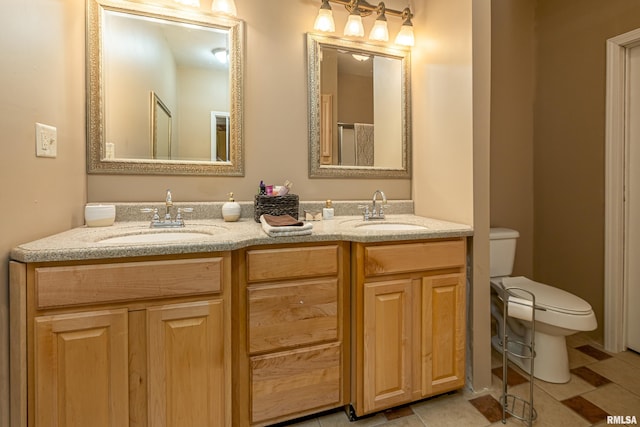 bathroom with tile patterned flooring, vanity, and toilet