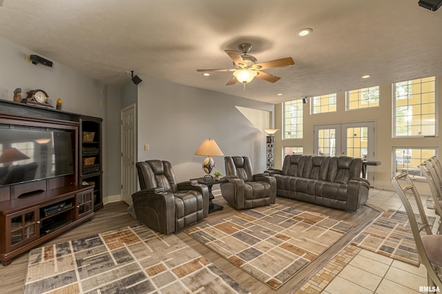 living room featuring tile patterned flooring, ceiling fan, and french doors