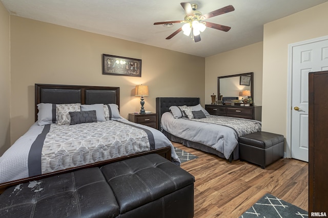 bedroom with wood-type flooring and ceiling fan