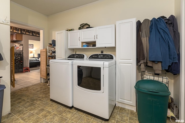 washroom featuring cabinets and washer and dryer