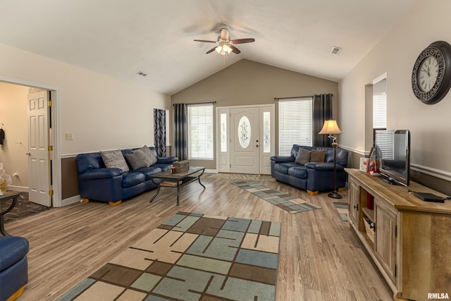 living room featuring vaulted ceiling, ceiling fan, and light hardwood / wood-style flooring