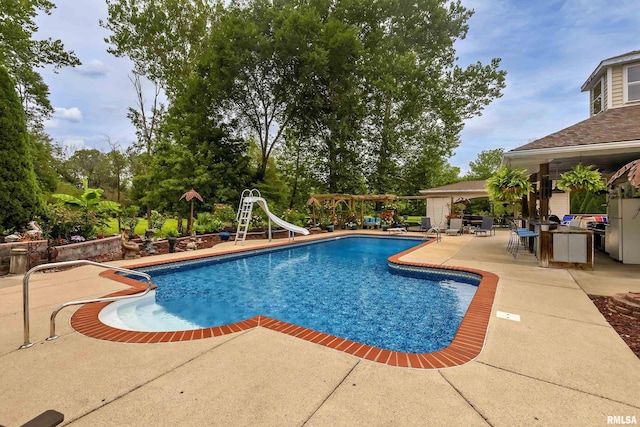 view of pool with a water slide, a pergola, and a patio area