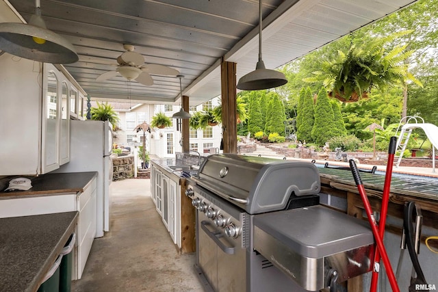 view of patio featuring area for grilling, sink, and ceiling fan