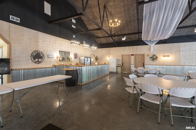 interior space with beam ceiling and high vaulted ceiling