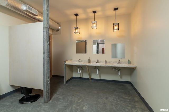 bathroom featuring sink and concrete floors