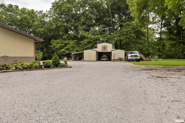 view of yard with a carport and an outdoor structure