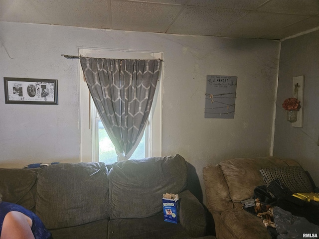 living room featuring a paneled ceiling