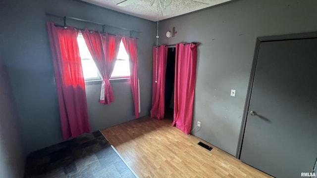 empty room featuring wood-type flooring and ceiling fan