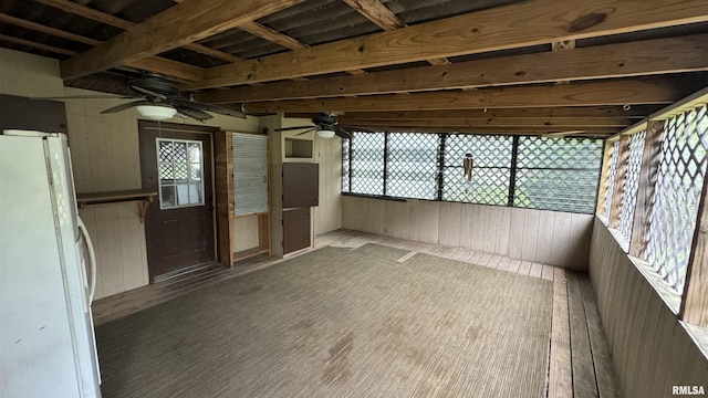 unfurnished sunroom with ceiling fan