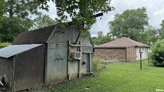 view of outdoor structure with a yard and cooling unit