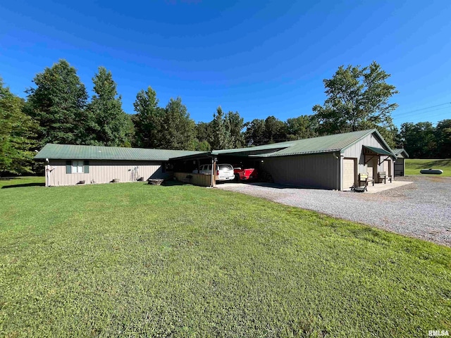 exterior space with a garage, an outbuilding, and a front lawn