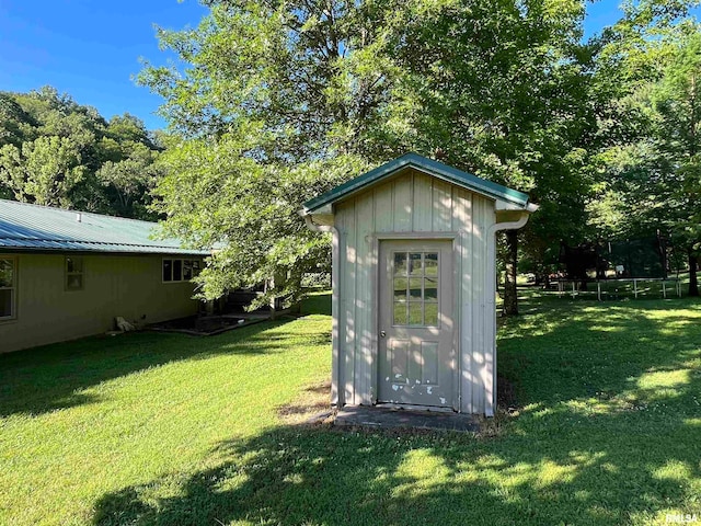 view of outbuilding with a yard