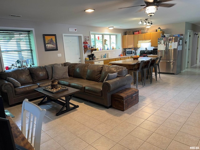 living room featuring ceiling fan and light tile patterned floors