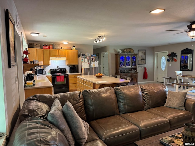 living room featuring rail lighting and ceiling fan